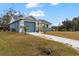 House exterior showcasing a blue garage door and a long driveway at 438 Leona St, Port Charlotte, FL 33954