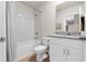 Clean bathroom with a shower/tub combo, white vanity, and granite countertop at 44197 Frontier Dr, Punta Gorda, FL 33982