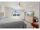 Main bedroom with large bed, dresser, and backyard view at 44197 Frontier Dr, Punta Gorda, FL 33982