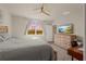 Main bedroom with large bed, dresser, and backyard view at 44197 Frontier Dr, Punta Gorda, FL 33982