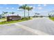 Entrance to Crescent Lakes community with palm trees and brick pavers at 44197 Frontier Dr, Punta Gorda, FL 33982