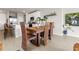 Bright dining area with wooden table and chairs, adjacent to kitchen at 44197 Frontier Dr, Punta Gorda, FL 33982