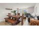 Dining area with a wooden table, bench seating, and gray sectional sofa at 44197 Frontier Dr, Punta Gorda, FL 33982