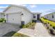 Tan house with a two-car garage and a walkway at 44197 Frontier Dr, Punta Gorda, FL 33982