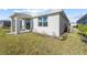 Single story home with grassy backyard and covered patio at 44197 Frontier Dr, Punta Gorda, FL 33982