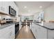 White kitchen with granite countertops and stainless steel appliances at 44197 Frontier Dr, Punta Gorda, FL 33982