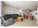 Open concept living room and dining area with grey sectional sofa and wooden dining table at 44197 Frontier Dr, Punta Gorda, FL 33982