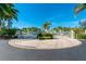 Gated entrance to waterfront community, featuring palm trees and manicured landscaping at 5116 Melbourne St # B201, Punta Gorda, FL 33980