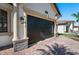 Dark brown garage door with stone columns at 7209 Carvel St, Englewood, FL 34224