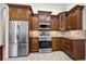 Modern kitchen with dark wood cabinets and stainless steel appliances at 7209 Carvel St, Englewood, FL 34224