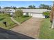 Ranch-style home with attached garage and walkway at 8 Oakwood N Dr # 8, Englewood, FL 34223