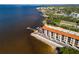 Aerial view of waterfront condo building with private docks and parking at 900 E Marion Ave # 1403, Punta Gorda, FL 33950