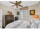 Comfortable bedroom with a ceiling fan and large window at 900 E Marion Ave # 1403, Punta Gorda, FL 33950