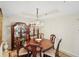 Elegant dining room featuring a wood table, crystal chandelier, and display cabinets at 900 E Marion Ave # 1403, Punta Gorda, FL 33950