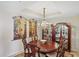 Elegant dining room features a large table and a crystal chandelier at 900 E Marion Ave # 1403, Punta Gorda, FL 33950