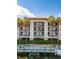 Three-story building with balconies, waterfront access, and a terracotta roof at 900 E Marion Ave # 1403, Punta Gorda, FL 33950