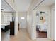 Bright hallway with access to two bedrooms and exterior door at 900 E Marion Ave # 1403, Punta Gorda, FL 33950