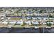 Aerial perspective of a waterfront community featuring homes with private pools and docks at 115 Leland Se St, Port Charlotte, FL 33952