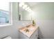 Bathroom featuring vanity, updated fixtures, window, and great lighting at 115 Leland Se St, Port Charlotte, FL 33952
