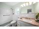 Bathroom with tiled shower, updated vanity, and grab bars, ensuring safety and comfort at 115 Leland Se St, Port Charlotte, FL 33952