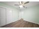 Bright bedroom with hardwood floors, closet, and ceiling fan; great natural light at 115 Leland Se St, Port Charlotte, FL 33952