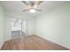 Bedroom with sliding glass door to an enclosed area; light-colored walls and new flooring at 115 Leland Se St, Port Charlotte, FL 33952