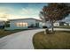 Charming mid-century home with a circular driveway and manicured lawn at 115 Leland Se St, Port Charlotte, FL 33952