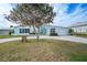 Charming single-story home with a landscaped yard and circular driveway at 115 Leland Se St, Port Charlotte, FL 33952