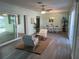Bright living room with modern seating and a dining area, open to the outdoors through sliding glass doors at 115 Leland Se St, Port Charlotte, FL 33952