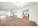 Open-concept living room featuring modern flooring, ceiling fans, and a view into the updated kitchen at 115 Leland Se St, Port Charlotte, FL 33952