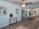 Bright living space with neutral walls and modern decor, seamlessly connecting to additional rooms and a patio at 115 Leland Se St, Port Charlotte, FL 33952