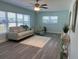 Cozy living room with ample natural light, featuring a comfortable sofa and stylish accent chair, perfect for relaxation at 115 Leland Se St, Port Charlotte, FL 33952
