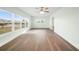Bright living area featuring stylish flooring, modern ceiling fan and natural light from windows at 115 Leland Se St, Port Charlotte, FL 33952