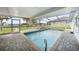 Private enclosed pool with outdoor seating and beautiful landscaping for relaxation at 115 Leland Se St, Port Charlotte, FL 33952