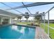 Enjoy the sunshine in this screened in pool area with brick pavers, and canal views at 115 Leland Se St, Port Charlotte, FL 33952
