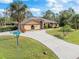 Aerial view of house and street with landscaping at 1160 Rizzo St, Port Charlotte, FL 33952