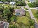 Aerial view of a house with a pool and spacious backyard in a quiet neighborhood at 1160 Rizzo St, Port Charlotte, FL 33952