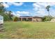 Spacious backyard with screened patio and lush lawn at 1160 Rizzo St, Port Charlotte, FL 33952