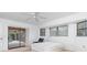 Bedroom with sliding glass doors opening to a screened lanai and pool area at 1160 Rizzo St, Port Charlotte, FL 33952