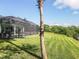 Landscaped yard with pool and screened enclosure at 1228 Eppinger Dr, Port Charlotte, FL 33953