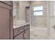 Clean bathroom with single vanity, tub, and shower at 1228 Eppinger Dr, Port Charlotte, FL 33953