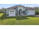 Newly built home with light green facade, tile roof, and well-manicured lawn at 1228 Eppinger Dr, Port Charlotte, FL 33953
