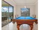 Game room boasts a blue pool table and plenty of natural light at 1228 Eppinger Dr, Port Charlotte, FL 33953