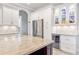 Elegant kitchen with white cabinets, granite counters, and wine cooler at 1228 Eppinger Dr, Port Charlotte, FL 33953