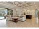 Spacious living room with coffered ceiling, sliding glass doors, and pool view at 1228 Eppinger Dr, Port Charlotte, FL 33953