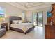 Main bedroom with plush bed, access to the backyard and large dresser at 1228 Eppinger Dr, Port Charlotte, FL 33953