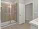 Modern bathroom featuring tiled shower with glass door and neutral tones at 16031 Alcira Cir, Punta Gorda, FL 33955