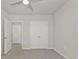 Neutral bedroom with ceiling fan, carpeting, and a double-door closet at 16031 Alcira Cir, Punta Gorda, FL 33955