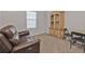 Guest bedroom featuring carpeted floors, a hutch, and a leather couch at 16031 Alcira Cir, Punta Gorda, FL 33955