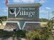Attractive 'Burnt Store Village' community sign, signifying a deed-restricted neighborhood with well-maintained landscaping at 16031 Alcira Cir, Punta Gorda, FL 33955